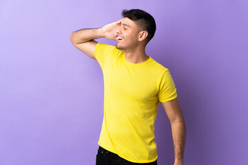 Young Colombian man isolated on purple background smiling a lot