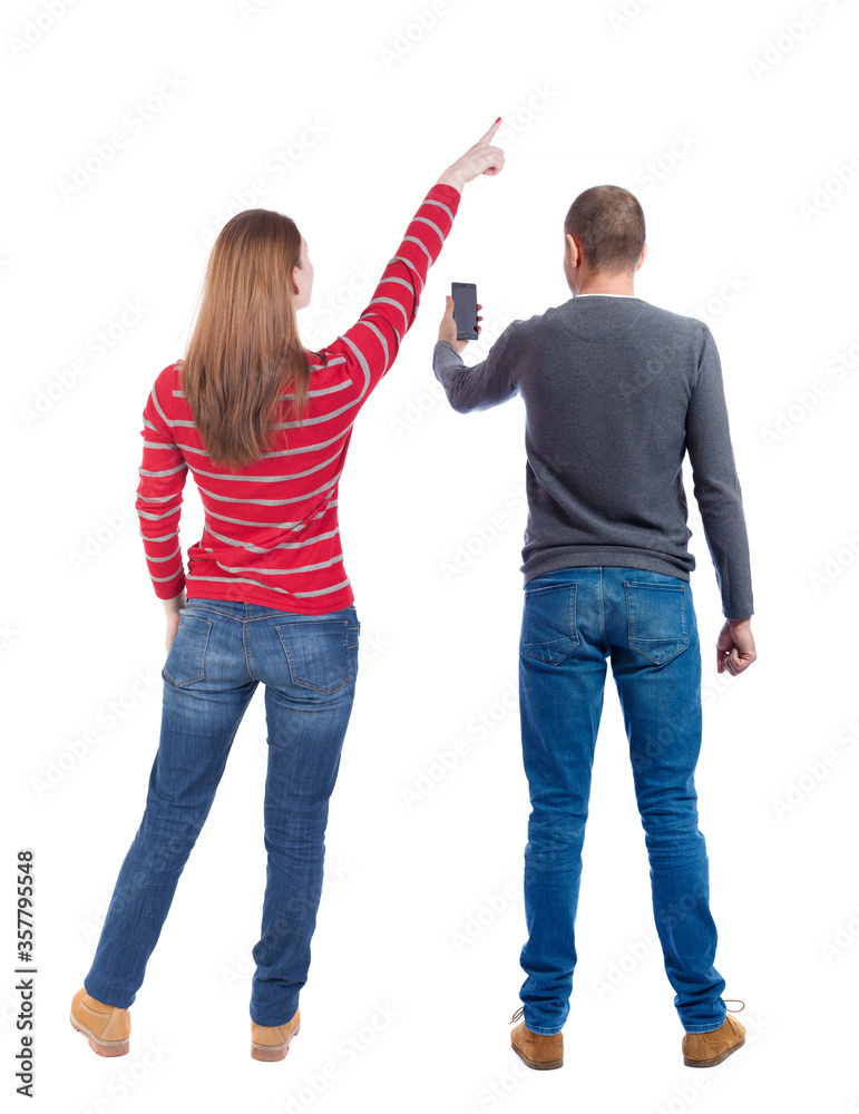 Poster Back view of couple in sweater with mobile phone.