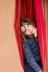 Fototapeta na wymiar portrait of a pretty little girl relaxing in a hammock