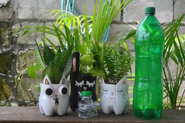 Recycled colored flower pots made of used plastic bottles. Nice decoration for inside and outside.