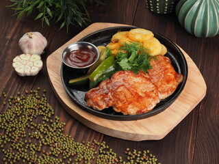 Grilled pork escalope with BBQ sauce and potato slices