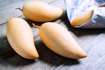 Barracuda mangoes on wooden table. Sweet and delicious Thai fruit. Close up