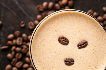 cup of coffee with beans on and on the background