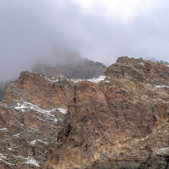Square Rocky mountain scenery with overcast sky overhead in Provo Canyon Utah in winter