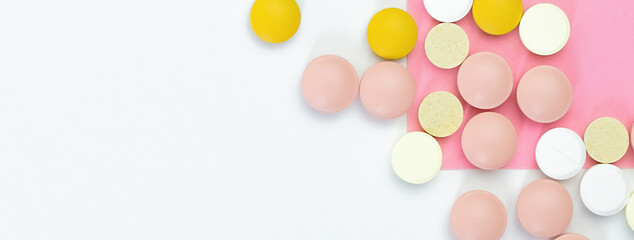 Pile of Pills colorful on a white - pink background. Medical concept