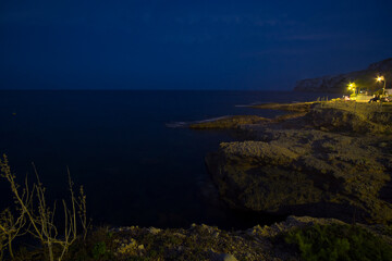 view of the sea at night Las Rotas beach in Denia Spain