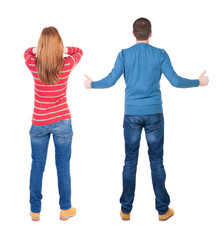 Obraz premium Back view of couple in sweater showing thumbs up.