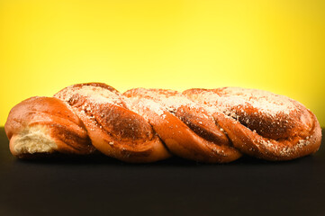 Homemade bread baking on a black and yellow background