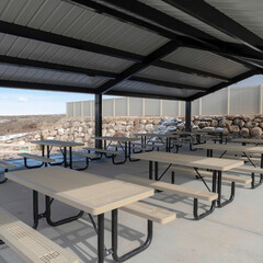 Square crop Tables with seats inside a gabled roof pavilion in South Jordan City in Utah