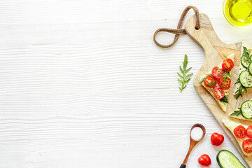 cooking vegan avocado sandwiches. Cutting board on white table copy space