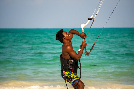 Young Attractive Muscular And Strong Athletic Black African Man Kite Surfing Instructor Teacher At The White Sand Beach