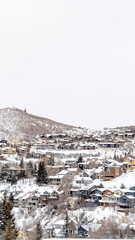 Vertical frame Park City Utah mountainscape with homes on a snowy neighborhood in winter