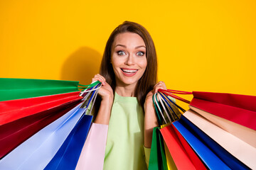Photo of charming shocked lady good mood street look hold many shopping bags open mouth cool sales...