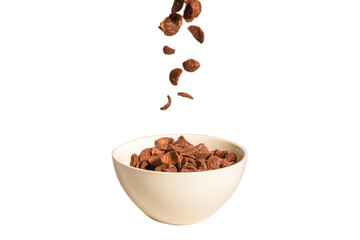 Chocolate corn flakes falling to the white bowl isolated on white. Motion.