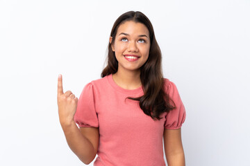 Young Colombian girl over isolated white background pointing up and surprised