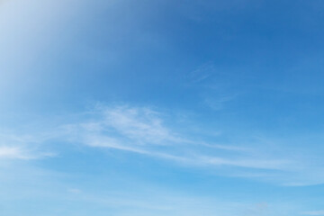 Naklejka na ściany i meble Beautiful sunny blue sky background with white clouds