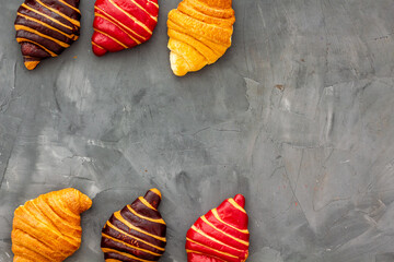 Set of croissants - chocolate, berry, classic - on gray table top view