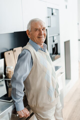 Fototapeta premium smiling elderly man on kitchen during quarantine