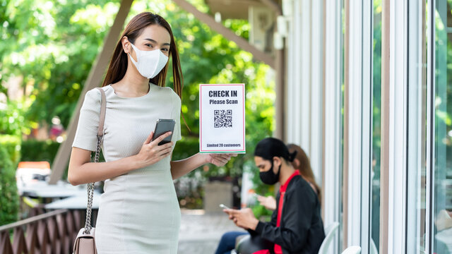 Woman use smartphone scan qr code for entering restaurant for application track and trace customer