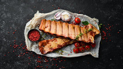 Smoked pork ribs with spices and herbs. Top view. Free space for text.
