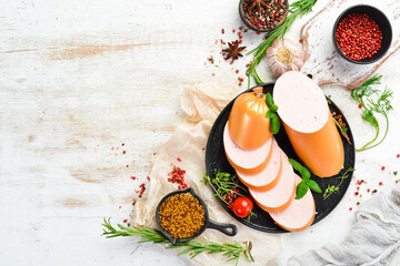 Boiled chicken sausage with spices. Top view. Free space for text. © Yaruniv-Studio