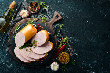 Fototapeta na wymiar Boiled chicken sausage with spices and herbs. Top view. Free space for text.