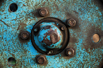 Blue rusty wheel from a tractor close up