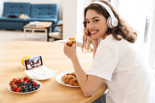 Photo Of Woman Watching Movie On Mobile Phone While Having Breakfast