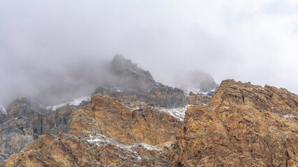 Fototapeta na wymiar Panorama Misty clouds over the rugged and rocky slope of Provo Canyon mountain in Utah