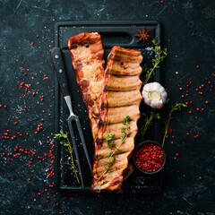 Smoked pork ribs with spices and herbs. Top view. Free space for text.