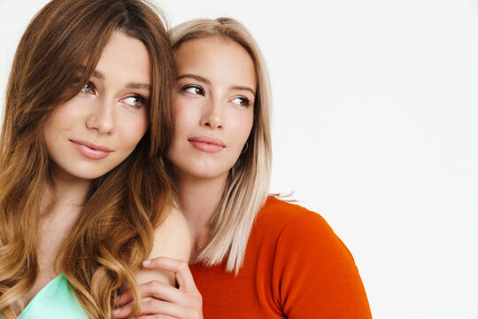 Image Of Pretty Beautiful Two Women Hugging And Looking Aside