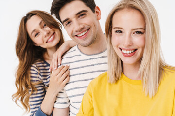 Image of cheerful man and women smiling and looking at camera