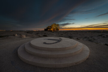 Fototapeta na wymiar Beautiful sunset view from Tree of Life, Bahrain. The Tree of Life in Bahrain is a 9.75 meters high Prosopis cineraria tree that is over 400 years old