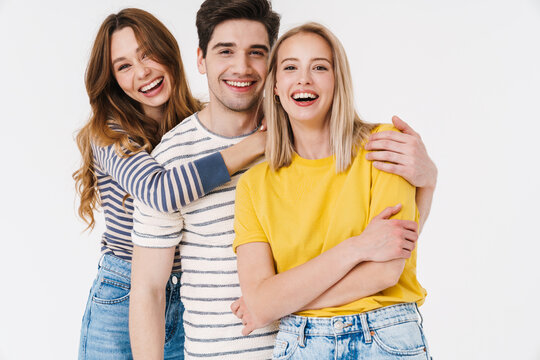 Image of cheerful man and women hugging and laughing at camera