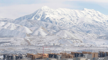 Panorama Snowy Wasatch Mountain towering over the neighborhood of South Jordan in Utah