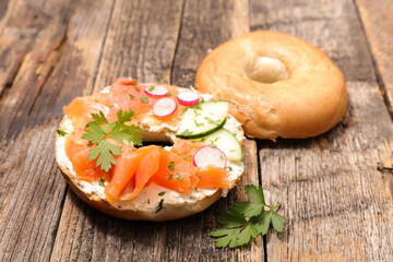 bagel sandwich with smoked salmon, cheese cream and radish