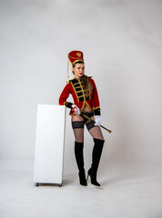 beautiful girl in a red hussar costume with a sword