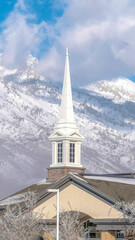Vertical Magnificent view of snow covered Wasatch Mountain with church in the foreground