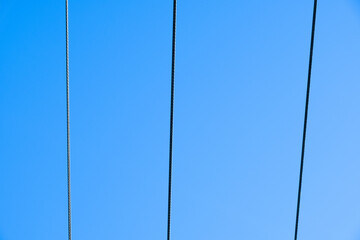An electric cable in blue sky background. Copy space for text
