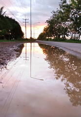 Pits and puddles on urban roads in residential areas, the concept of construction and repair of roads and streets in the city.