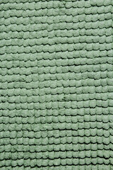 Microfiber texture with a soft large pile. Top view texture of light green big microfiber fabric towel. 