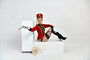 beautiful girl in a red hussar suit with a sword and with pistols