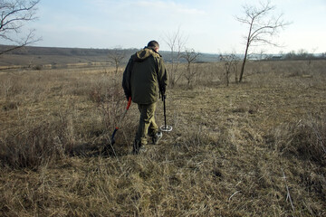 man with a metal detector in search of historical values.