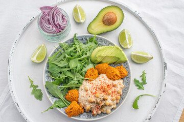 Vegan lunch bowl with quinoa, hummus, chickpeas, avocado, 