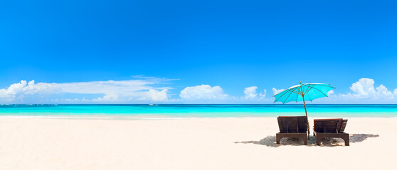Panorama of tropical beach with white sand and turquoise water.
