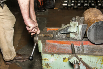 hands of the master make repairs in the machine shop.