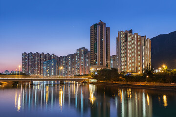 Fototapeta na wymiar High rise residential building and mountain in Hong Kong city at dusk