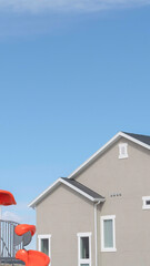 Vertical frame Childrens playground at a park in South Jordan City against exterior of house