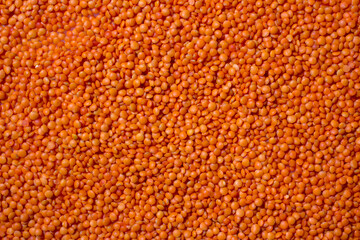 Background with red lentils. Lots of lentils. Raw ingredients for cooking. Healthy, clean eating concept.