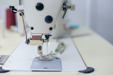 Close-up of sewing machine foot. Seamstress equipment